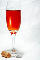 glass of red wine on white