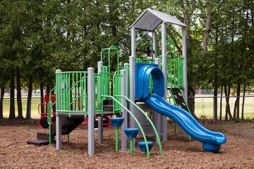 Fototapeta na wymiar Colorful empty playground in park without kids