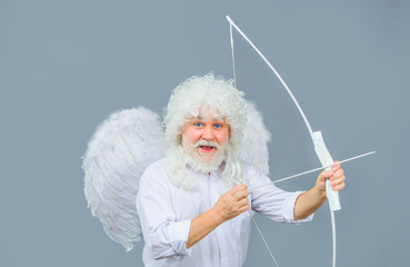 Arrow of love. Cupid throws arrow with bow. Bearded angel with bow and arrow. Cupid angel with bow...