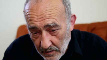 Closeup portrait of senior, elderly mature man having eyesight problems trying to read emails via a mobile device. Human emotions and facial expressions. Age related changes. 4K, Close up, Static Shot - Powered by Adobe