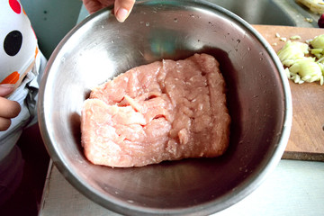 minced meat in a bowl, chopped onion, close-up