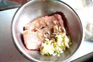 minced meat in a bowl, chopped onion, pepper, close-up