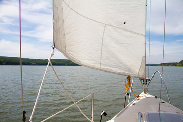 Fototapeta premium Shine Yacht tackle during voyage over sea waves, sailing concept.