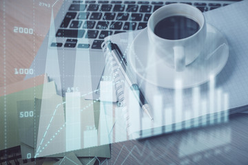Double exposure of forex chart drawing and desktop with coffee and items on table background. Concept of financial market trading
