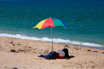 Multi colored beach umbrella on a sandy beach