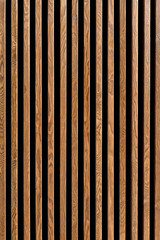 Texture of wood lath wall background. Seamless pattern of modern wall paneling with vertical wooden...