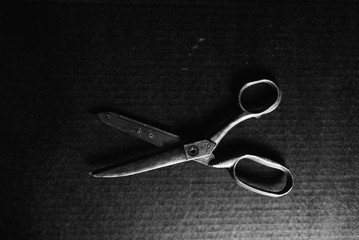 old scissors on black background