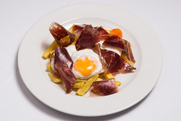 Typical Spain food named huevos rotos.