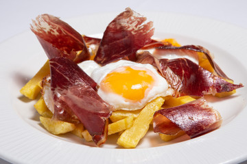 Typical Spain food named huevos rotos.