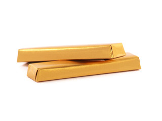 Chocolate bars wrapped in golden aluminum foil isolated on white