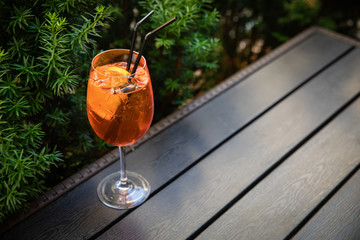 orange alcoholic drink Aperol in glasses with ice. Stand on a table in the backyard
