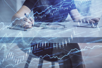 Double exposure of businesswoman hands typing on computer and forex chart hologram drawing. Financial analysis concept.