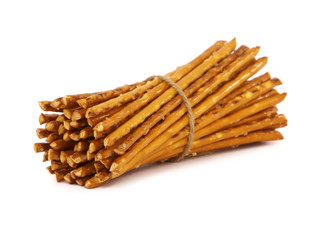 Pretzel sticks with salt tied with string, isolated on a white