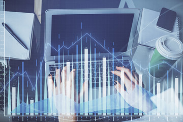 Double exposure of woman hands typing on computer and forex chart hologram drawing. Stock market invest concept.