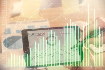 Double exposure of man's hands holding and using a phone and financial chart drawing. Market analysis concept.