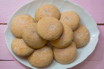 Homemade cookies on a white dish close-up. Fresh baked goods. Home cooking concept