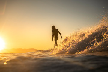 Surfing at sunset, Byron Bay Australia