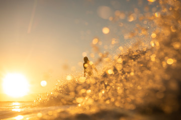 Obraz na płótnie Canvas Surfing at sunset, Byron Bay Australia