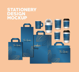 mockup set og bags and mugs with blue and leaves branding of corporate identity and stationery design theme Vector illustration © Grgroup