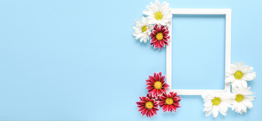 Mockup square white frame with white and red flowers on blue background. View top. Messege or invitation card mock-up concept. flower layut. copy space for text. Banner
