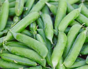 fresh green peas on wooden surface