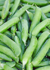 fresh green peas on wooden surface
