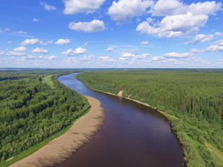Bends of the river and blue sky with clouds. Sysola river, Komi Republic, Russia.