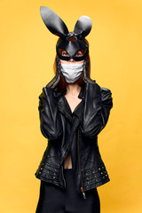  Female rabbit mask posing sexually in a medical mask from coronavirus