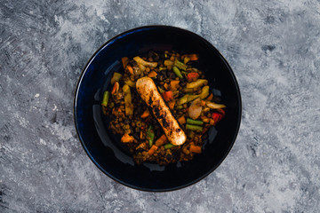plant-based food, asian vegetables and lentils stir fry with vegan sausage