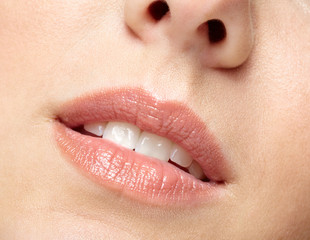 Naklejka premium Closeup macro portrait of female part of face. Human woman lips with day beauty makeup