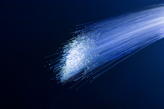 colorful optical fibres dinamic flying from deep on technology background