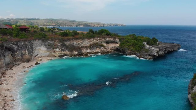 Drone shot taken in Nusa Lembongan which is an island located southeast of Bali, Indonesia. It is part of a group of three islands that make up the Nusa Penida district. Tropical clear blue water.