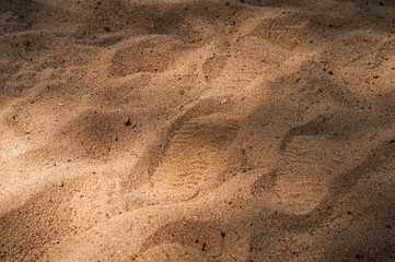 Shoe print in the middle of the sand with contrast