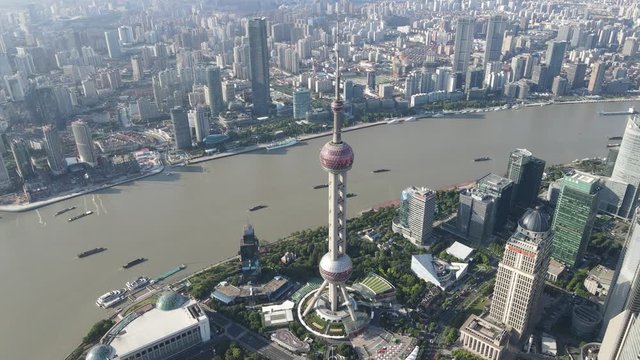 Aerial view of Shanghai downtown Lujiazui financial district skyline and cityscape. Cozy drone point of view footage. Tourism travel concept. Shanghai Oriental Pearl TV Tower and Huangpu River