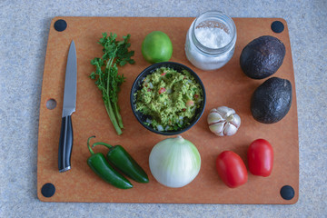 Ingredients to prepare guacamole sauce with small knife