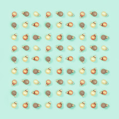 Golden shiny small Christmas balls, New Year greeting card retro toned with copy space on mint color background.