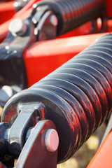 Steel spring in industrial or agricultural machinery. Part of hydraulic or pneumatic equipments