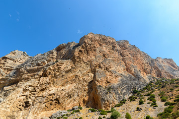 Fototapeta na wymiar View of rocky mountain cliff and blue sky
