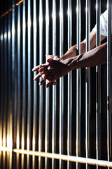 Obraz premium close up of prisoner hand in jail