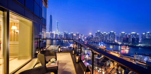 This luxury house by the Huangpu River in Shanghai, China has an open-air balcony with a beautiful...