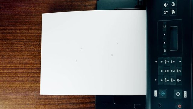 Office desktop laser printer printing single A4 letter page