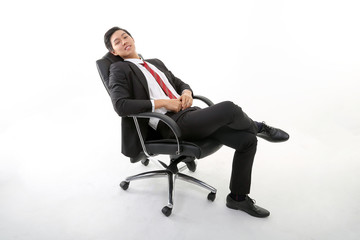 Asian young Chinese man wearing formal business office ware on white background sitting on office chair relax think success happy worried