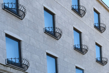 Hanger for flower pots, Wrought Iron planter boxes installation on windows, Concept background image of green eco living idea for prefabrication facade. 