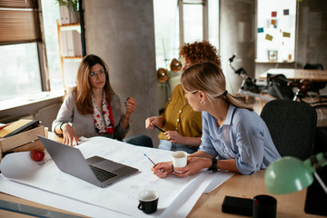 Businesswomen working on a new project. Colleagues discussing about problem they have to solved.