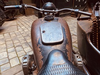 Old vintage  metal motorcycle with the gun on it