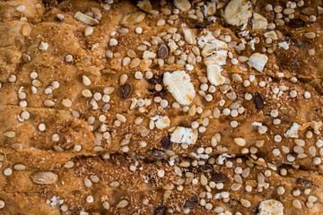 close up of bread with some grains on a plate
