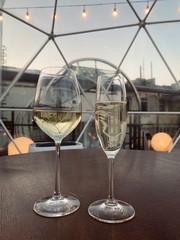 The two glasses on the table with drink. Sunset view