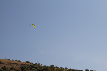 Paragliding for two on a sunny summer day. Extreme sport, adventure sports. Paraglider over the beach