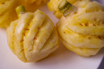 Phulae pineapple on a plate on a wooden background