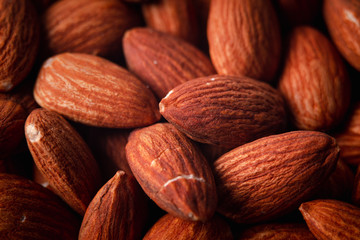 Pile of almonds close-up as background.